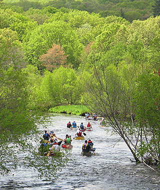 Paddlers on the Blackstone River during the annual spring canoe race